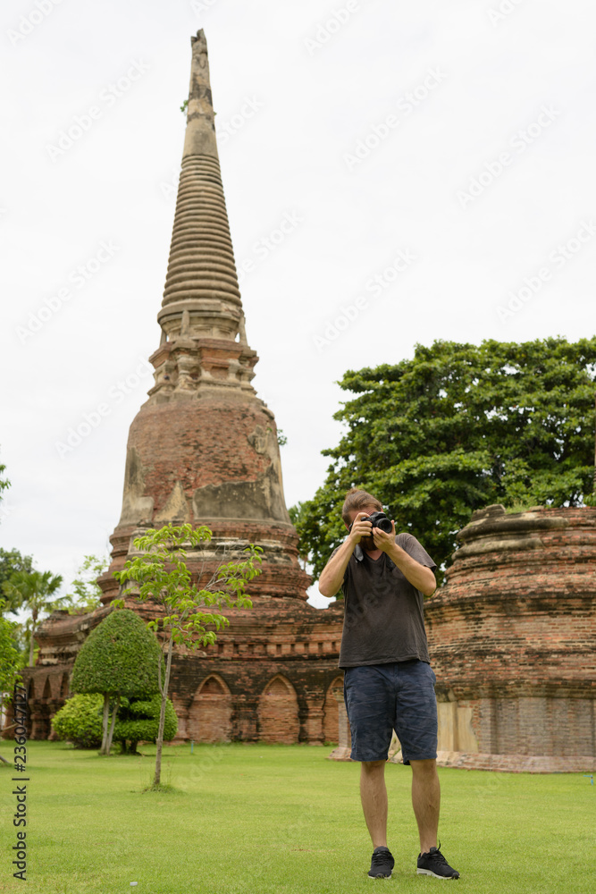 Young bearded tourist man having vacation in Ayutthaya, Thailand