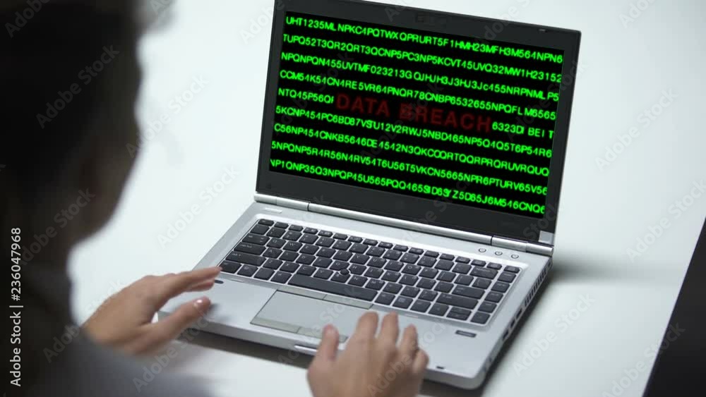 Data breach attack on laptop computer, woman working in office, cybercrime Data breach attack on laptop computer, woman working in office, cybercrime