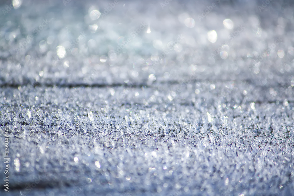 Obraz premium Rime cover on the ground. Hoarfrost on wooden surface outdoors.