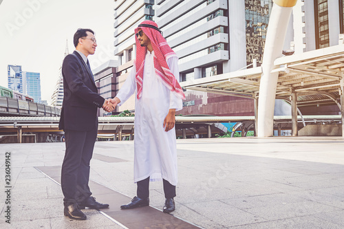 Photography Arabic businessman giving an handshake to his business partner, on construction