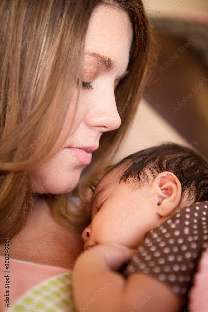 Portrait of a mother holding a new born baby. Portrait of a mother holding a new born baby.