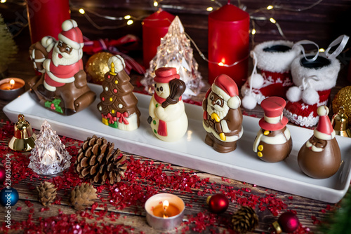 Christmas and winter holidays table night with Santa chocolate Set with Christmas decorations.