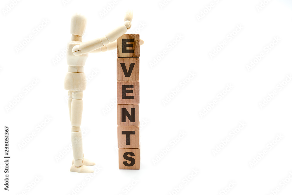 Wooden figure as businessman building Events as tower of wood cubes Wooden figure as businessman building Events as tower of wood cubes