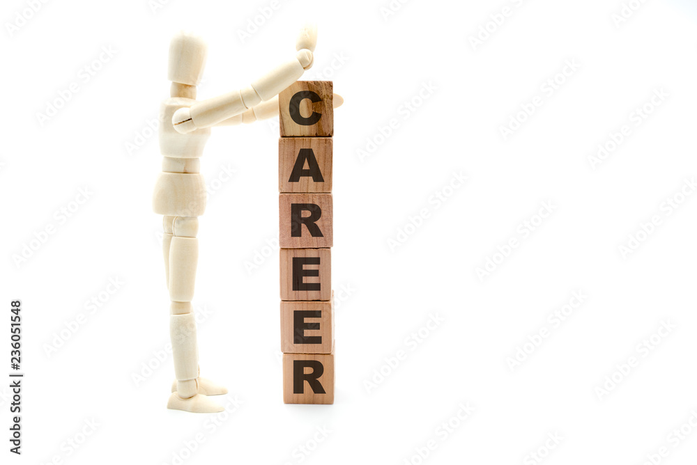 Wooden figure as businessman building Career as tower of wood cubes Wooden figure as businessman building Career as tower of wood cubes