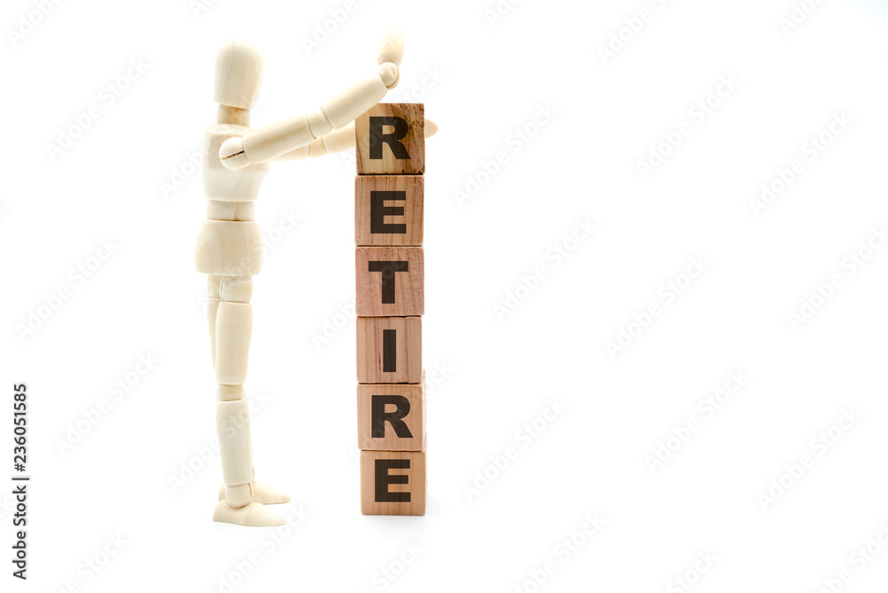 Wooden figure as businessman building Retire Concept as tower of wood cubes Wooden figure as businessman building Retire Concept as tower of wood cubes