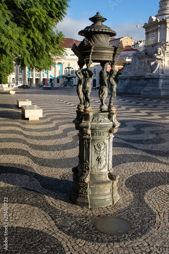 Lisbon / Portugal - November 07: 2018. small monument view during Sunrise in Square Pedro IV / Rossio square in Lisbon, Portugal