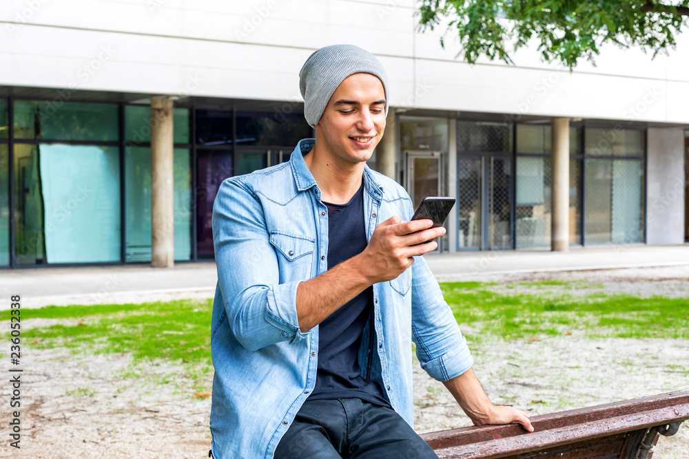 Outdoor portrait of modern young man with mobile phone in the street. Outdoor portrait of modern young man with mobile phone in the street.