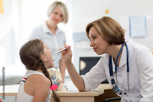 Little child girl opening mouth for checkup at doctors office