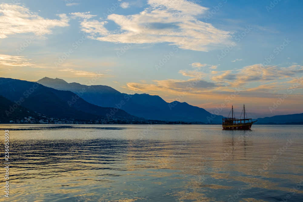 Montenegro, Kotorsky gulf, Adriatic Sea. Dawn, ship, mountains.