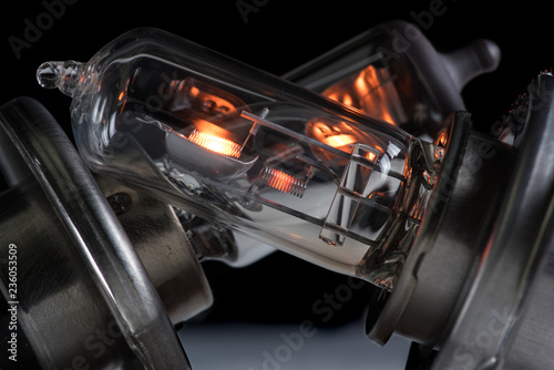 Incandescent lamp for dipped and main beam headlights with burning spiral on a black background