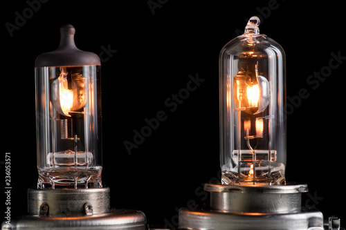 Incandescent lamp for dipped and main beam headlights with burning spiral on a black background