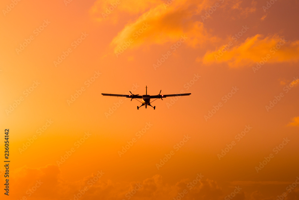 Silhouette of an airplane at sunset.