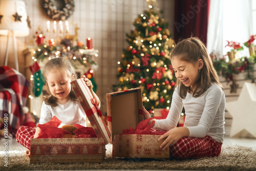 girls opening Christmas gifts