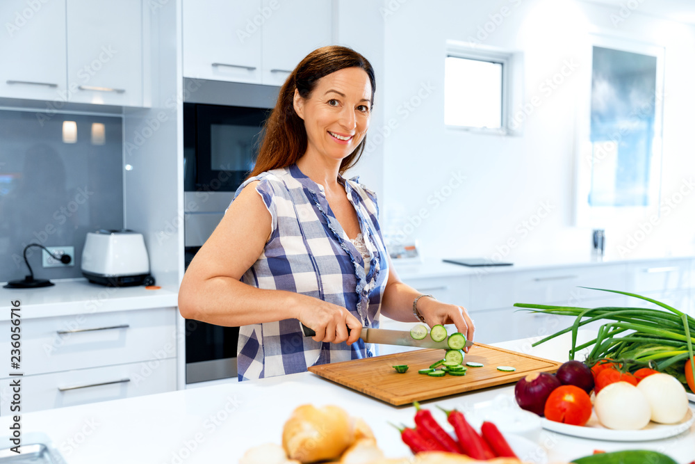 Beautiful woman standing in the kitchen Beautiful woman standing in the kitchen