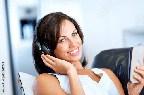 Young woman with headphones sitting at home