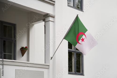 Canvas Print Algeria flag hanging on a pole in front of the house