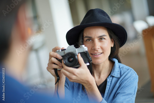  Trendy stunning brunette taking photos of model with vintage camera