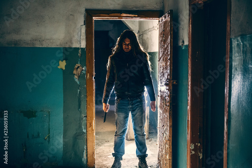 Konstfotografi Silhouette of criminal or maniac with knife in hand in old scary building, seria