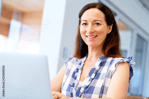 Mature beautiful woman working on her laptop