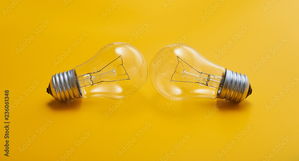 close up view of white light bulb isolated on yellow close up view of white light bulb isolated on yellow