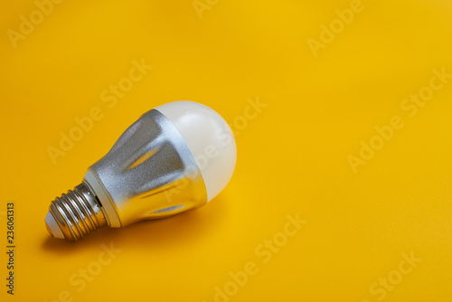 Led light bulb lay next to incandescent bulb. Concept energy saving