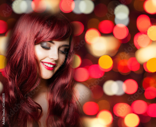 Redhead woman with long curly hairs on bright color party bokeh glitter background