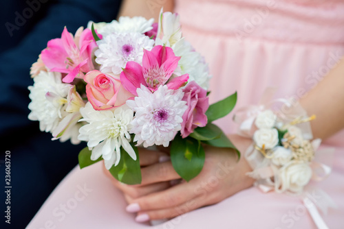 Glorious bridesmaids in pink dresses holding beautiful flowers - selective focus