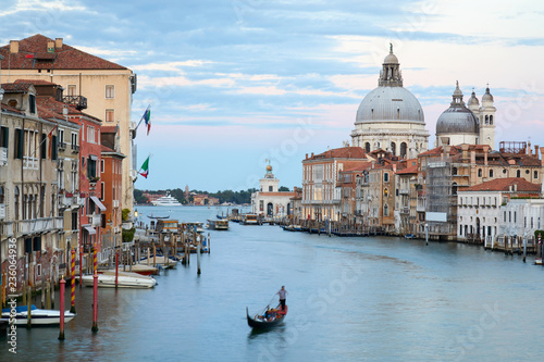 Grand Canal in Venice with gondola and Saint Mary of Health basilica at dusk in Italy © andersphoto