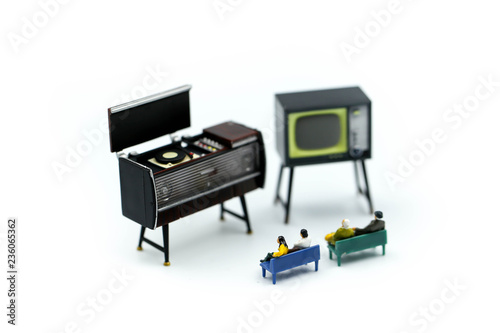 Miniature people : Parents Family watching television at home entertainment concept.
