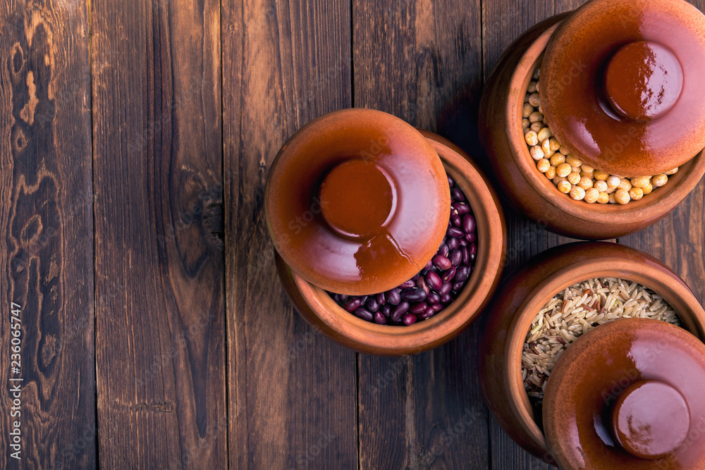 The concept of natural healthy food. Grains of various beans in a large ceramic pots, closeup. Superfood The concept of natural healthy food. Grains of various beans in a large ceramic pots, closeup. Superfood