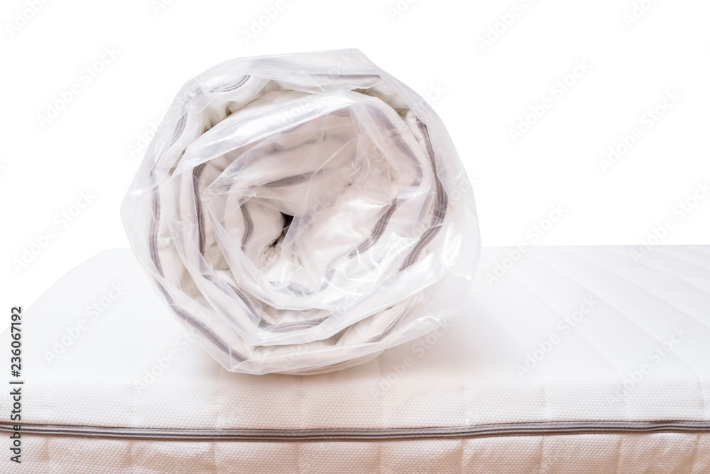 Roll of new mattress on the bed Roll of new mattress on the bed