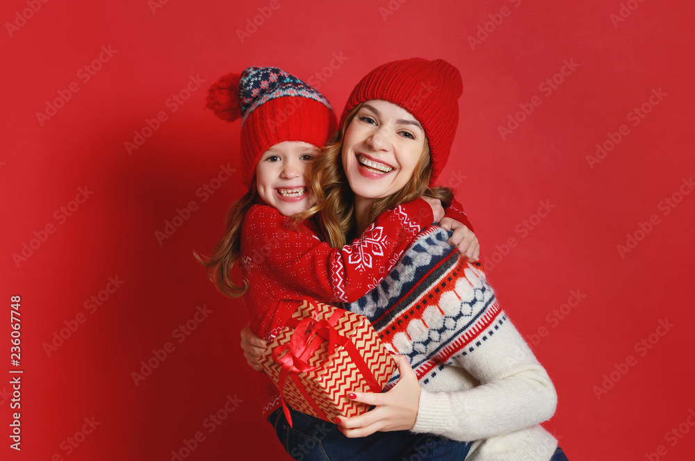happy family mother and child daughter with christmas gifts on red background happy family mother and child daughter with christmas gifts on red background