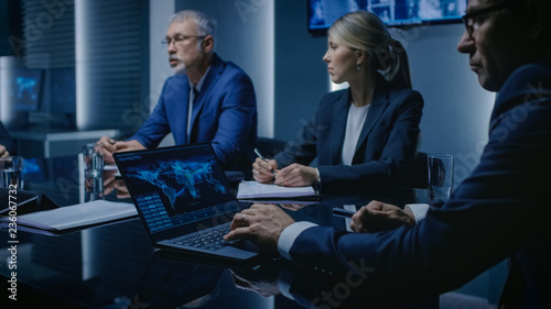 Government Agency Officials Having Discussion On the Emergency Meeting. Serious People Negotiating in Conference Room. In the Background Screens Showing Maps and Data Flow.