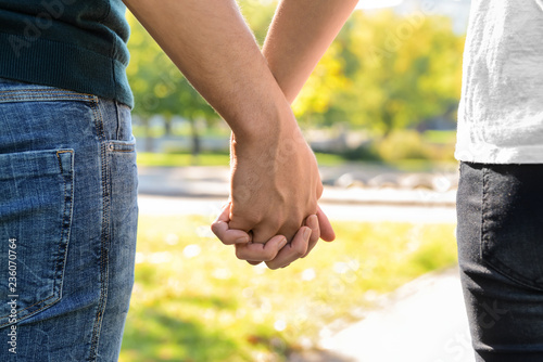 Young couple holding hands outdoors