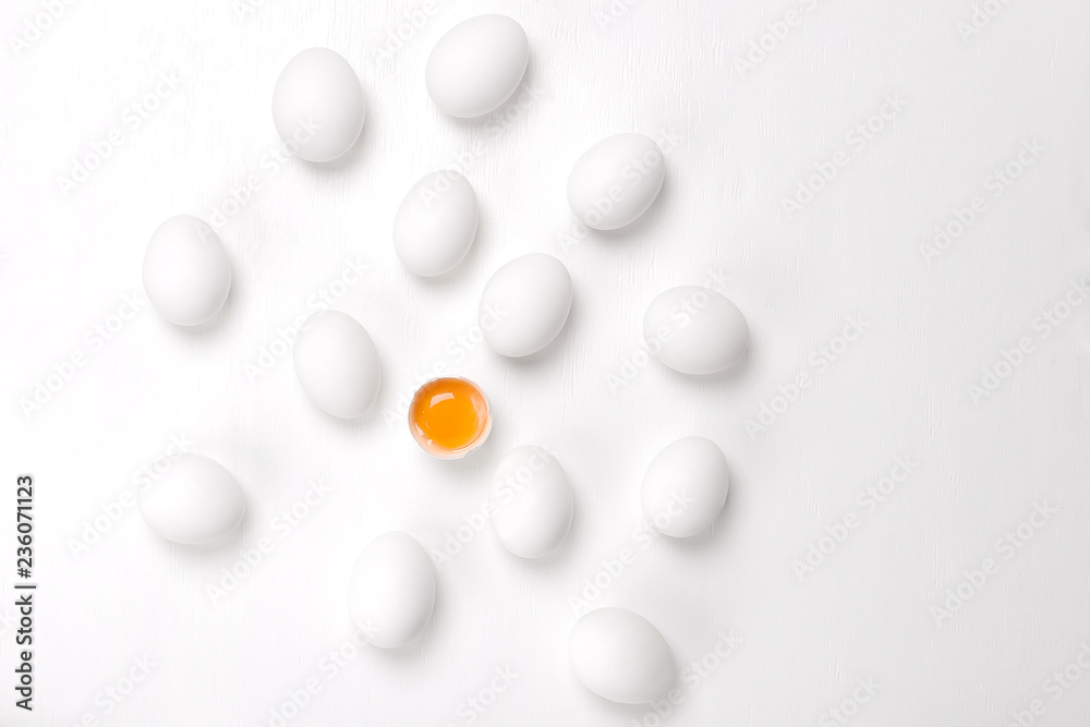 Eggs.One cracked and group of whole unheard eggs  on a white background.