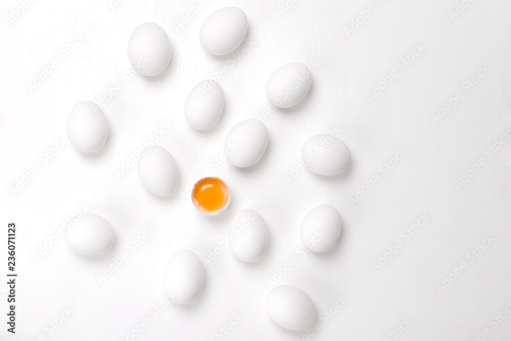 Eggs.One cracked and group of whole unheard eggs on a white background. Eggs.One cracked and group of whole unheard eggs on a white background.