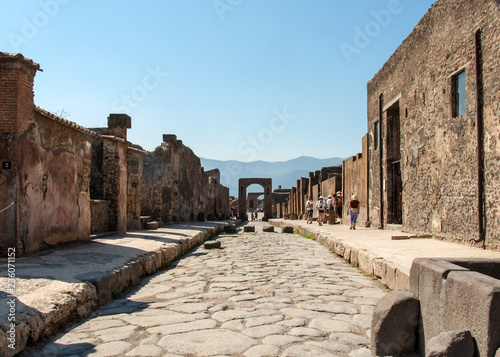 An ancient cobbled street in the ruins of Pompeii, Italy. Roman town destroyed by Vesuvius volcano.