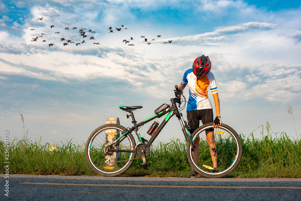 woman bicycle cyclist in trouble of front tire wheel needs repair and adjusting by herself on the road