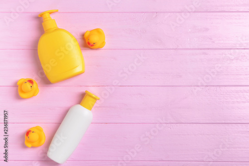Baby cosmetics on color wooden background, top view