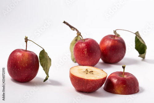 Small apple with green leaf on white background. ranetka photo