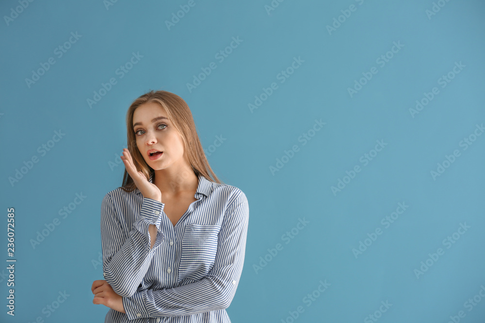 Fototapeta premium Emotional young woman after making mistake on color background