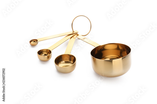 Different metal scoops on white background