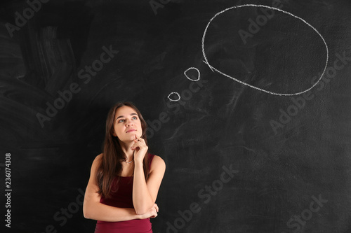 Thoughtful young woman near...