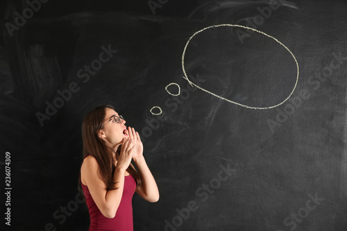 Young woman near blank spee...