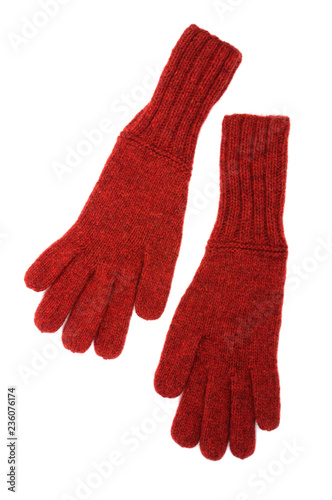 Red knitted gloves isolated on white background. Handwork. View from above.