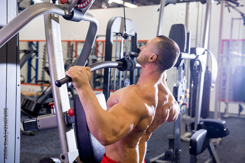 male bodybuilder doing exercises in a gym