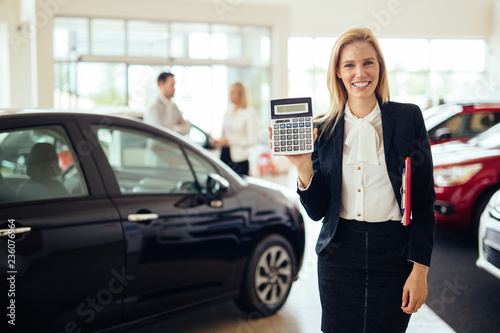 Portrait of young saleswoman in car dealership © NDABCREATIVITY
