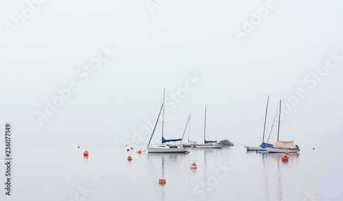 Obraz na płótnie Isolated boats in fog at Wolfgangsee, Austria w salonie