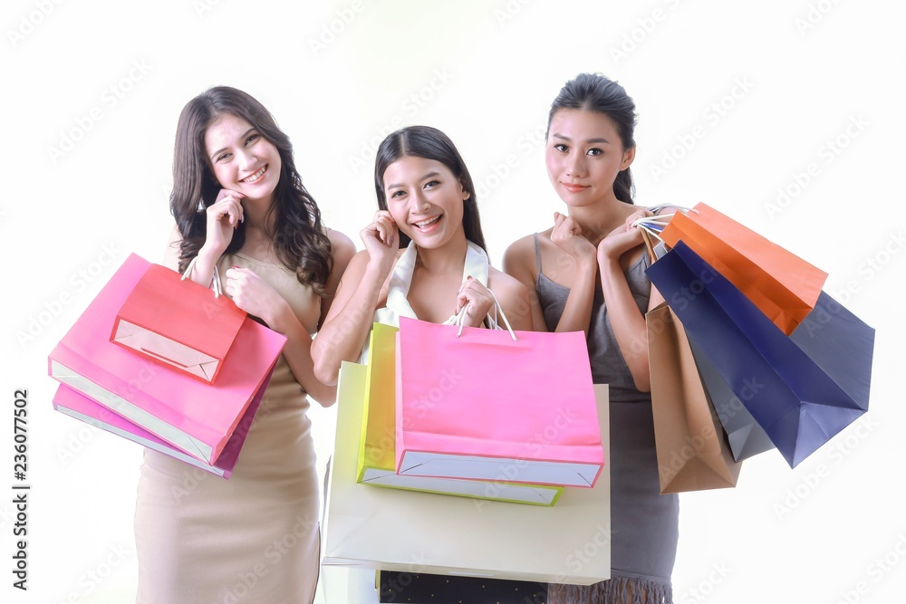 Three adorable girls carrying shopping bag front of white backgrouond isolated.