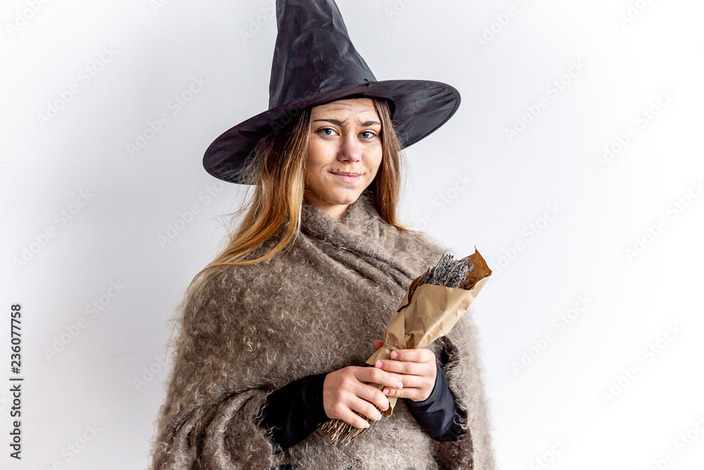 A young woman wearing a witch costume A young woman wearing a witch costume